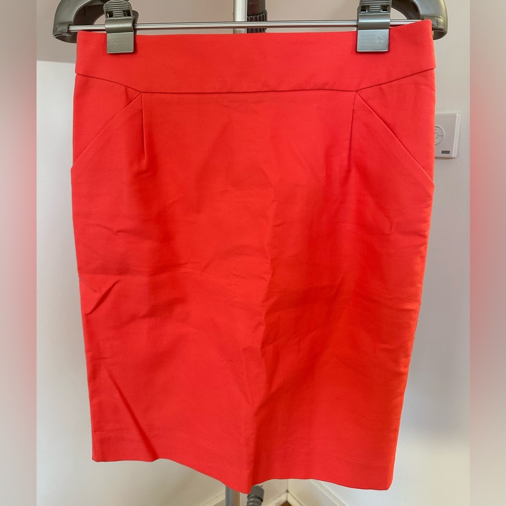 J Crew pencil skirt in coral, size 8. Never worn.